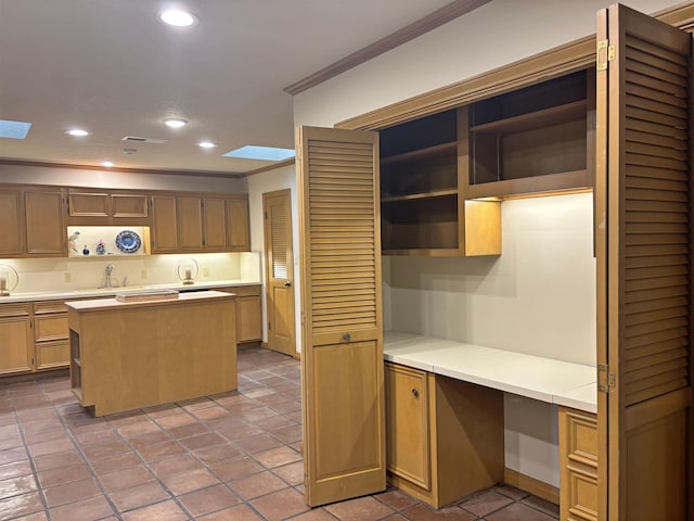 4370 Thomas Ln, Beaumont, TX 77706 - kitchen featuring open shelves, ornamental molding, a skylight, built in study area, and recessed lighting