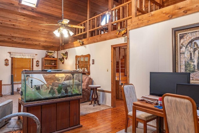 office area with ceiling fan, wooden ceiling, high vaulted ceiling, wooden walls, and hardwood / wood-style flooring