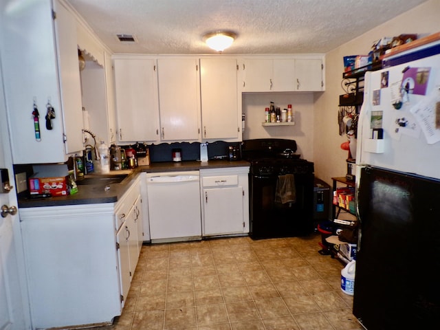 6162 E Dr, Groves, TX 77619 - kitchen with dishwasher, black gas range oven, freestanding refrigerator, dark countertops, and a textured ceiling