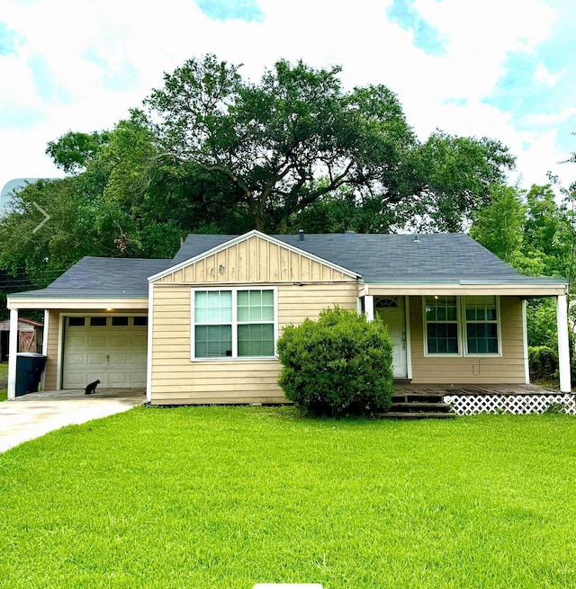 6162 E Dr, Groves, TX 77619 - ranch-style home featuring a front lawn, covered porch, a garage, driveway, and board and batten siding