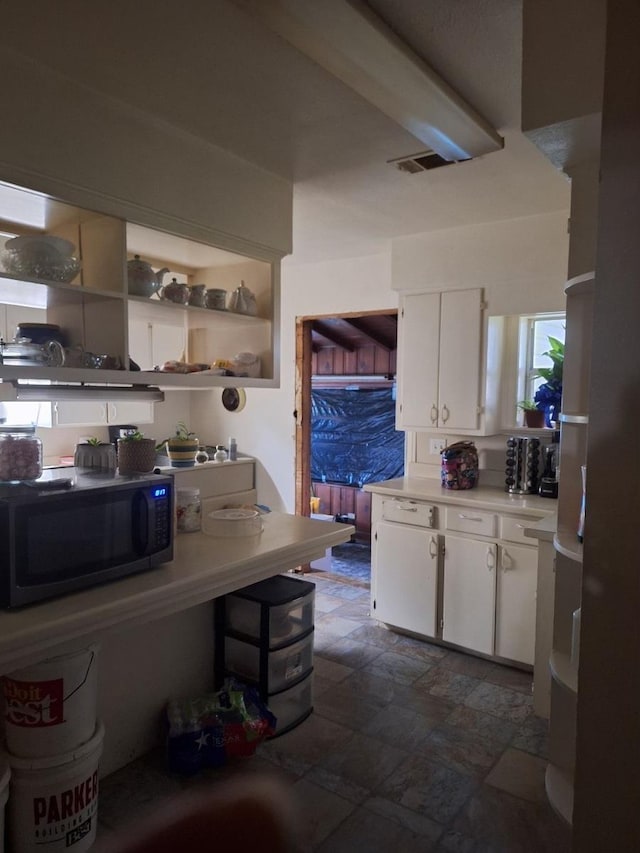 kitchen featuring white cabinets