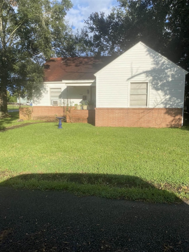 view of property exterior featuring a lawn