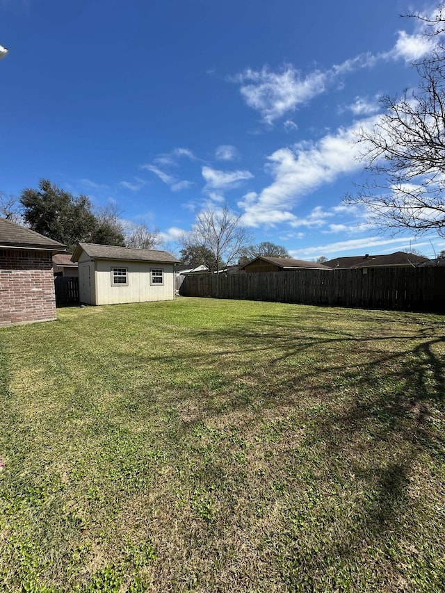 view of yard with fence and an outdoor structure