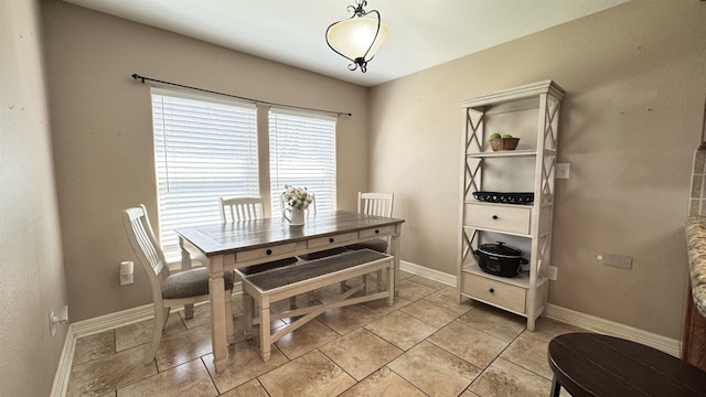 dining space featuring baseboards