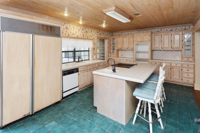 kitchen with paneled fridge, white dishwasher, a kitchen island with sink, wood ceiling, and tile counters