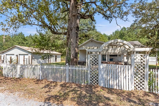 view of front of house featuring a fenced front yard and a pergola