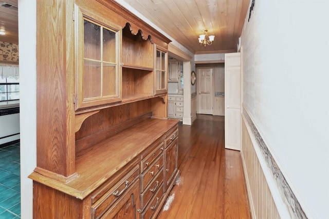 corridor featuring wood ceiling, dark wood finished floors, and a notable chandelier