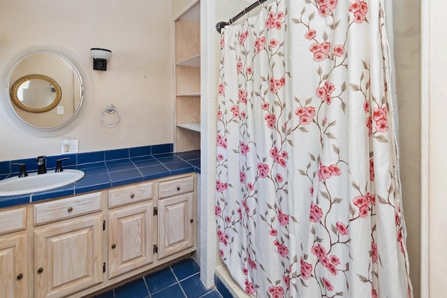 bathroom with a stall shower, vanity, and tile patterned floors