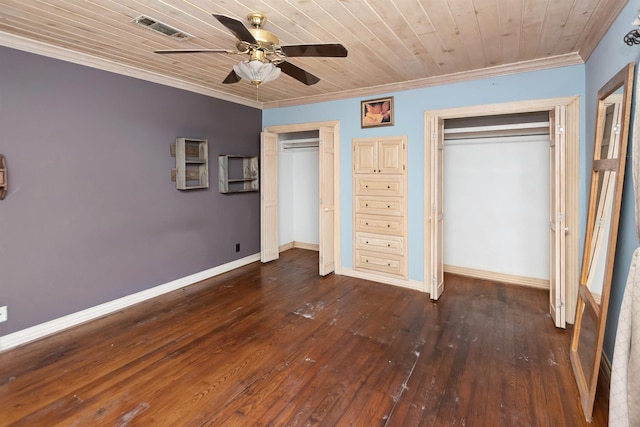 unfurnished bedroom featuring baseboards, crown molding, visible vents, and two closets