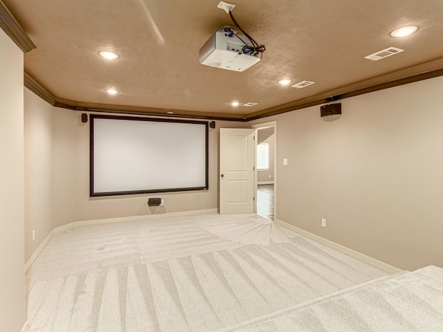 carpeted cinema room with ornamental molding