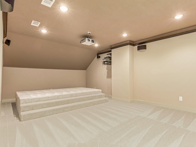 cinema room featuring carpet flooring and lofted ceiling