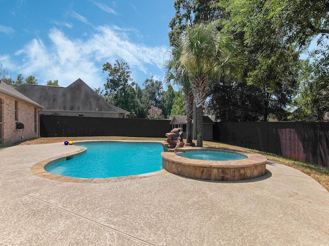 view of pool with a patio area and an in ground hot tub