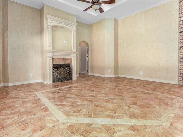 unfurnished living room featuring a tile fireplace, crown molding, and ceiling fan