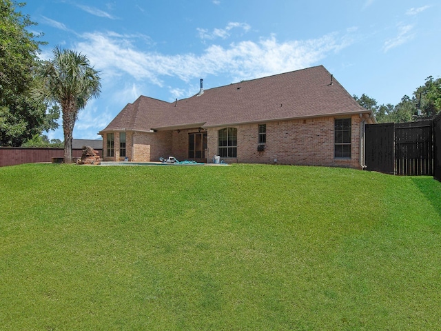 rear view of house with a lawn