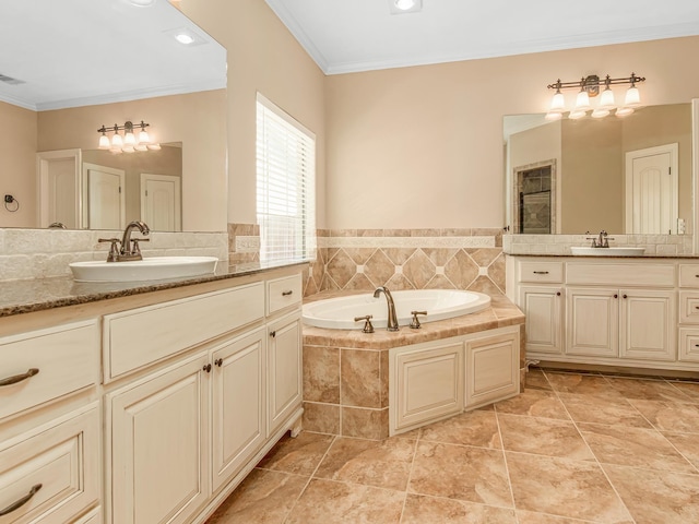 bathroom with tiled tub, crown molding, tile patterned flooring, and vanity