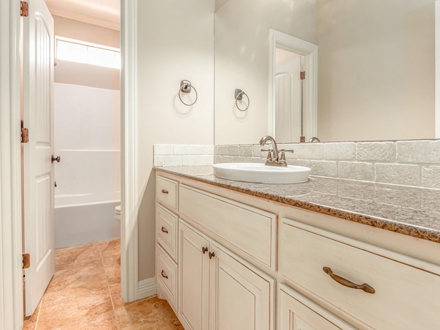 bathroom featuring toilet, vanity, and ornamental molding