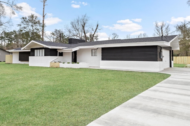 ranch-style house with a garage and a front yard