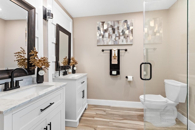 bathroom featuring toilet, walk in shower, and vanity