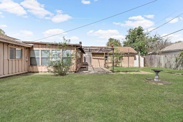 rear view of house featuring board and batten siding, a shed, an outdoor structure, and a pergola
