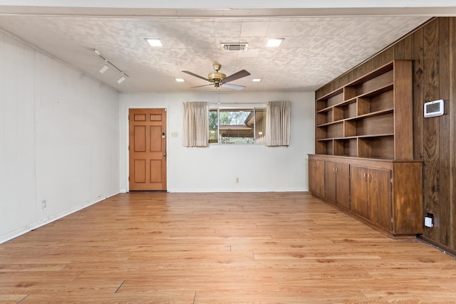 unfurnished living room with light wood-style floors and a ceiling fan