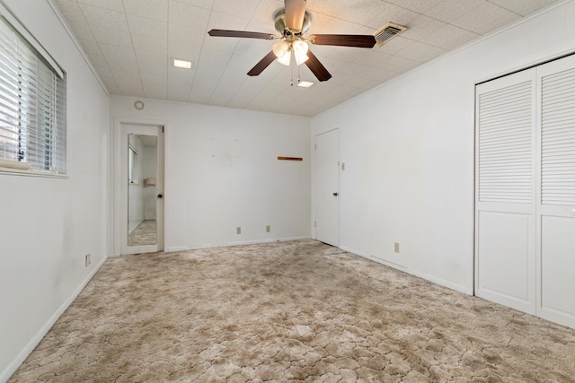 unfurnished bedroom featuring carpet floors and a ceiling fan