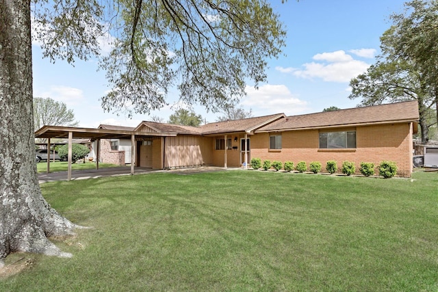view of front of house with brick siding, an attached carport, a front lawn, and central AC unit