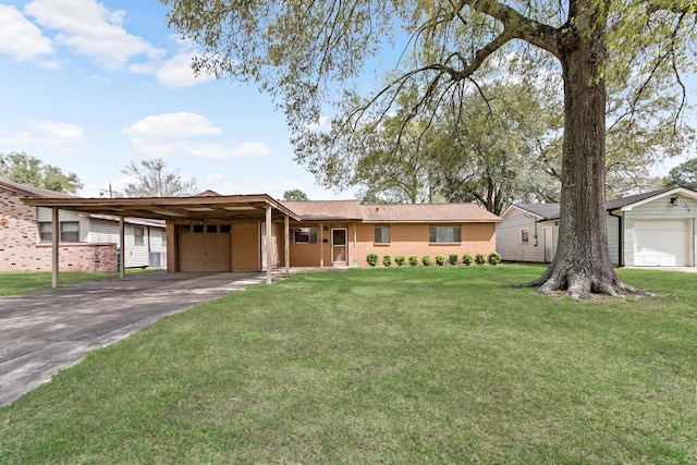 single story home featuring an attached garage, a front yard, asphalt driveway, and brick siding