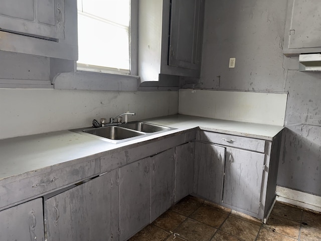 2726 13th St, Port Arthur, TX 77640 - kitchen with light countertops, gray cabinetry, and dark stone finish floors