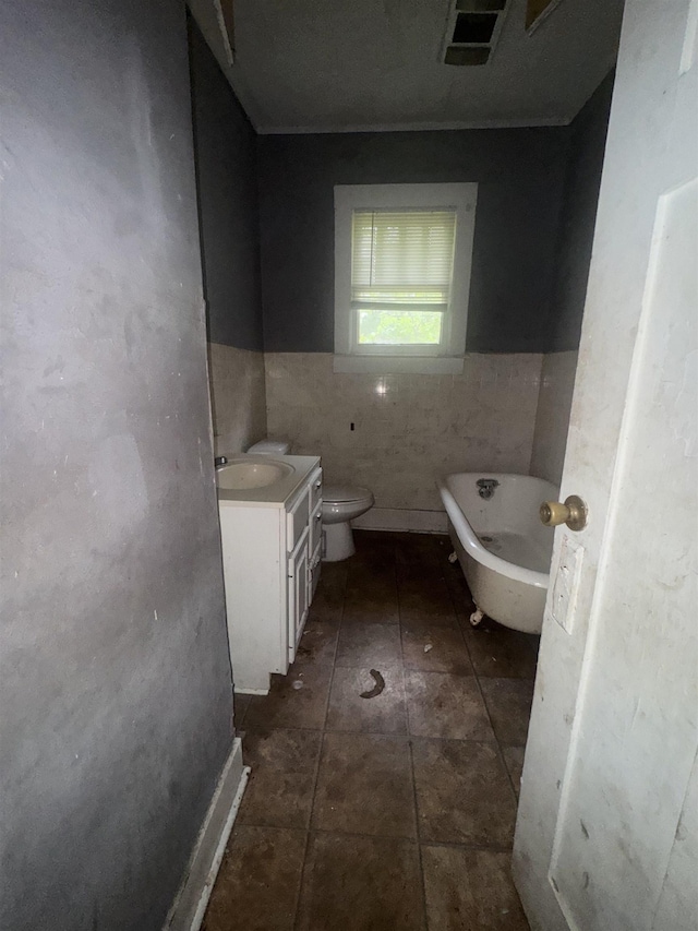 2726 13th St, Port Arthur, TX 77640 - full bath with a freestanding bath, tile walls, vanity, and a wainscoted wall