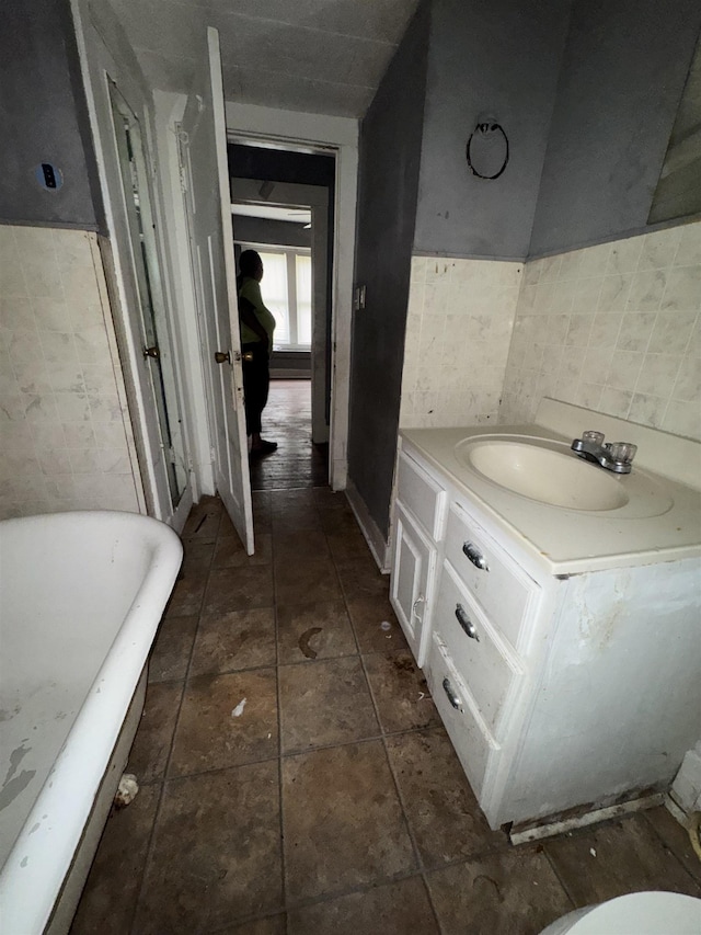2726 13th St, Port Arthur, TX 77640 - bathroom featuring a soaking tub, tile walls, and vanity
