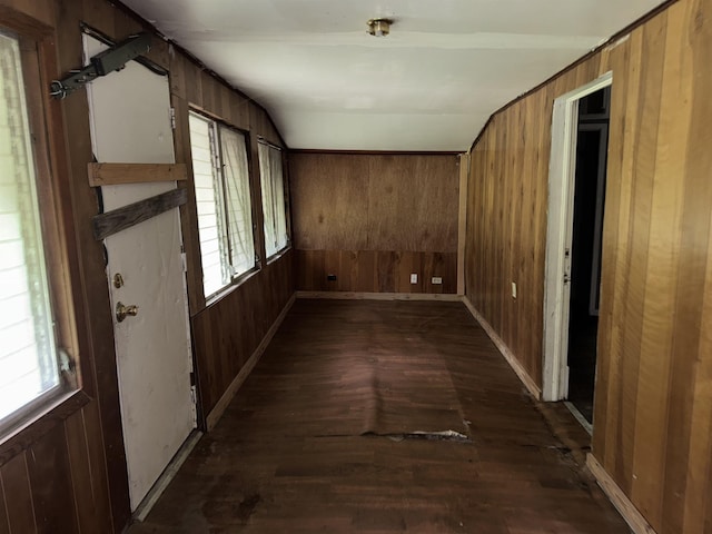 2726 13th St, Port Arthur, TX 77640 - corridor featuring wood walls, dark wood finished floors, healthy amount of natural light, and vaulted ceiling