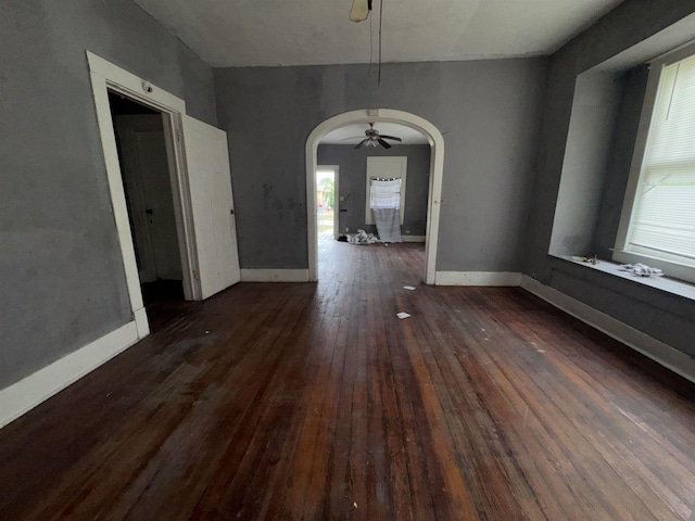 2726 13th St, Port Arthur, TX 77640 - unfurnished dining area with arched walkways, ceiling fan, and hardwood / wood-style flooring