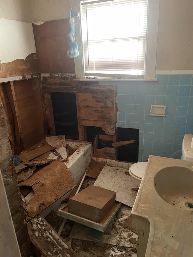 5129 5th St, Port Arthur, TX 77642 - bathroom featuring toilet, tile walls, wainscoting, and vanity