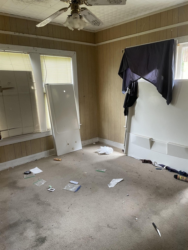 5129 5th St, Port Arthur, TX 77642 - spare room featuring ceiling fan, baseboards, and wood walls