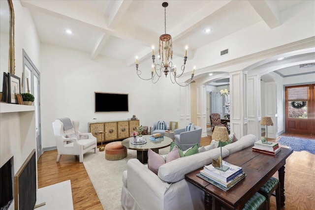 2175 Brewton Cir, Beaumont, TX 77706 - living room with arched walkways, a chandelier, light wood-style flooring, beam ceiling, and recessed lighting