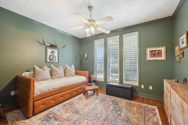 2175 Brewton Cir, Beaumont, TX 77706 - bedroom with wood finished floors, ornamental molding, a textured ceiling, baseboards, and ceiling fan