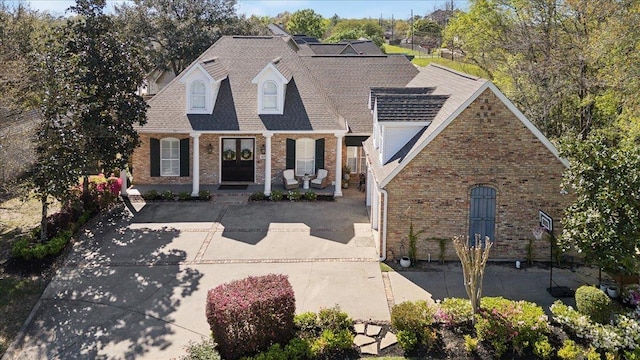 2175 Brewton Cir, Beaumont, TX 77706 - view of front of home with brick siding, covered porch, and a shingled roof