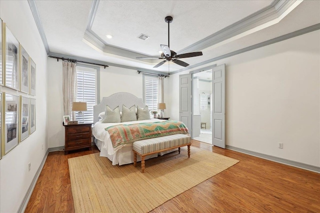 2175 Brewton Cir, Beaumont, TX 77706 - bedroom with a raised ceiling, crown molding, wood finished floors, baseboards, and ceiling fan