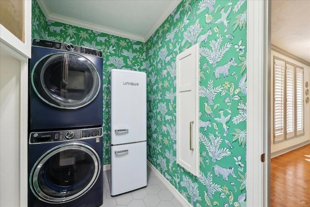2175 Brewton Cir, Beaumont, TX 77706 - laundry room featuring stacked washer / dryer, ornamental molding, wallpapered walls, and baseboards