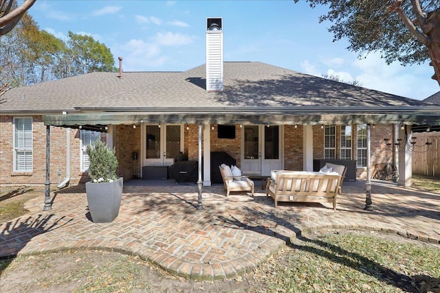 2175 Brewton Cir, Beaumont, TX 77706 - back of house featuring french doors, a patio area, brick siding, and an outdoor hangout area
