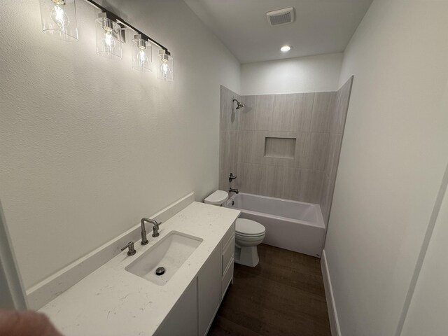 3547 Lily Ln, Beaumont, TX 77713 - bathroom featuring toilet, wood finished floors, shower / tub combination, vanity, and baseboards