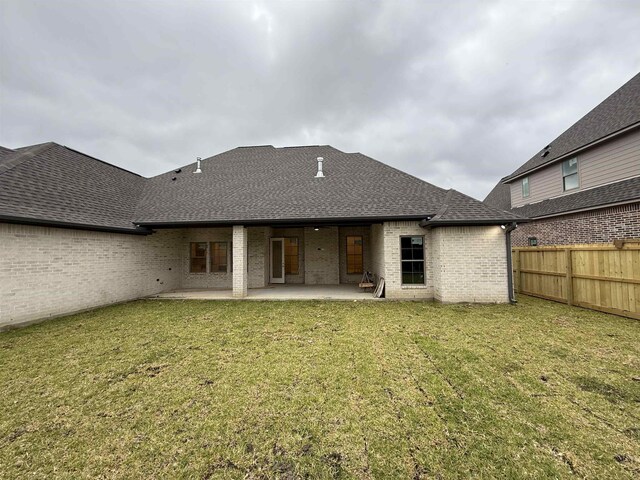 3547 Lily Ln, Beaumont, TX 77713 - rear view of house with a patio area, roof with shingles, and brick siding