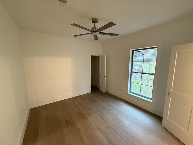 3547 Lily Ln, Beaumont, TX 77713 - unfurnished bedroom featuring wood finished floors, baseboards, and ceiling fan