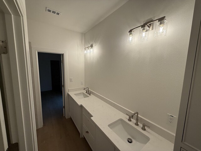 3547 Lily Ln, Beaumont, TX 77713 - bathroom with wood finished floors and double vanity