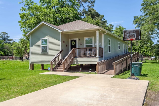 bungalow-style house featuring covered porch, a front yard, a shingled roof, and stairway