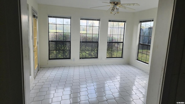 unfurnished sunroom with ceiling fan