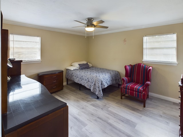 bedroom with ornamental molding, light hardwood / wood-style floors, and ceiling fan