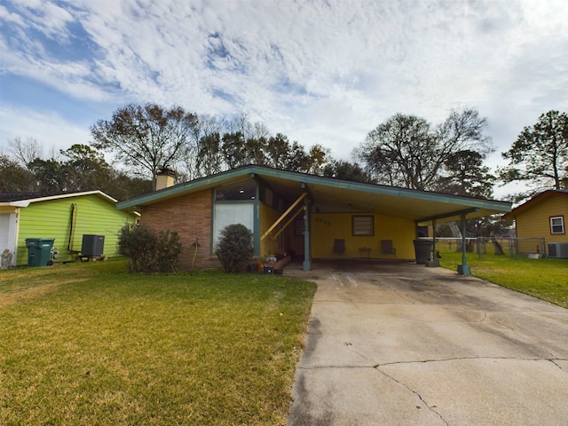 view of front of property featuring cooling unit, a carport, and a front yard