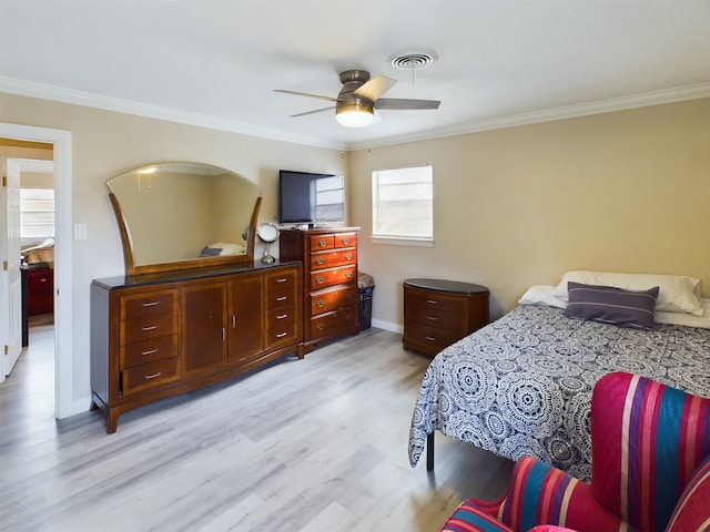 bedroom featuring crown molding, ceiling fan, and light wood-type flooring