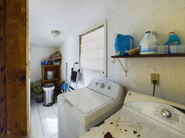 laundry area with light tile patterned floors and independent washer and dryer